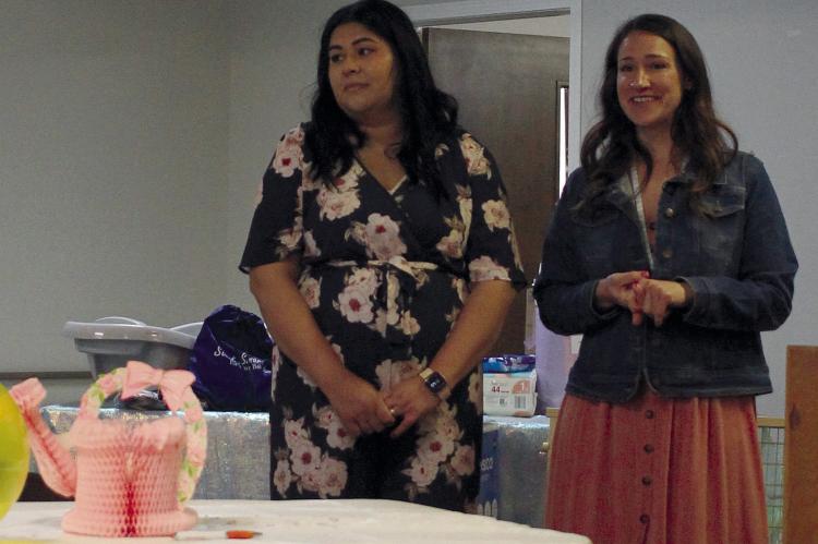 GABRIELA MEZA (LEFT) and Stephanie DeVeau, lactation counselors with Special Supplemental Nutrition Program for Women, Infants and Children (WIC) give a presentation about breastfeeding benefits at the community baby shower. SOPHIA BALES | Staff