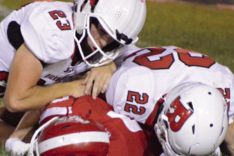 RICHMOND SOPHOMORES Bryson Pruitt (left) and Mack Misenhelter finish a tackle against Carrollton to help the Spartans post their first shutout this season in varsity 11-man football. SHAWN RONEY | Staff
