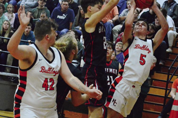 HARDIN-CENTRAL senior Kameron Pugh attempts a leaning jumper while teammate Jesse Doyle signals he’s open Dec. 21 against visiting Braymer. SHAWN RONEY | Staff