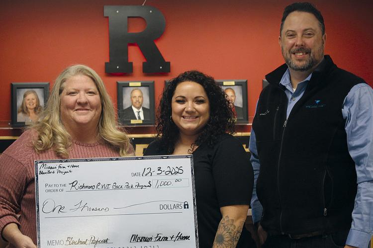 MISSOURI FARM AND HOME President and CEO Jimmy Carter (right) presents a $1,000 Bluebird Project donation to the Richmond School District staff Carrie Mueller (left) and Nicole Yoakum. SHARON DONAT | Staff