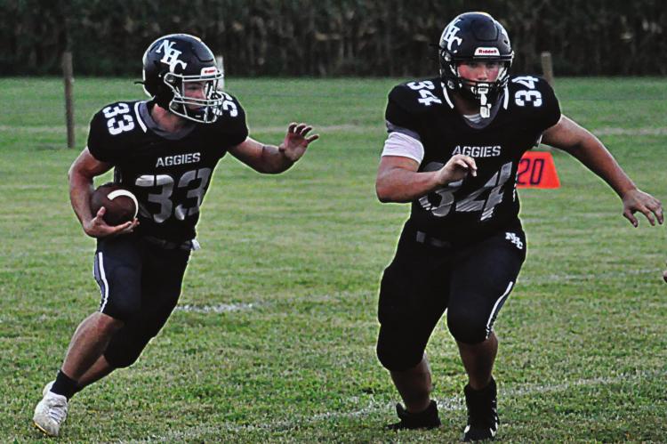 KEYTON LAIRE, No. 34, leads the way for running back Brayden Schick during Norborne Hardin-Central’s Sept. 3 varsity 8-man football clash with Knox County at Norborne. SHAWN RONEY | Staff