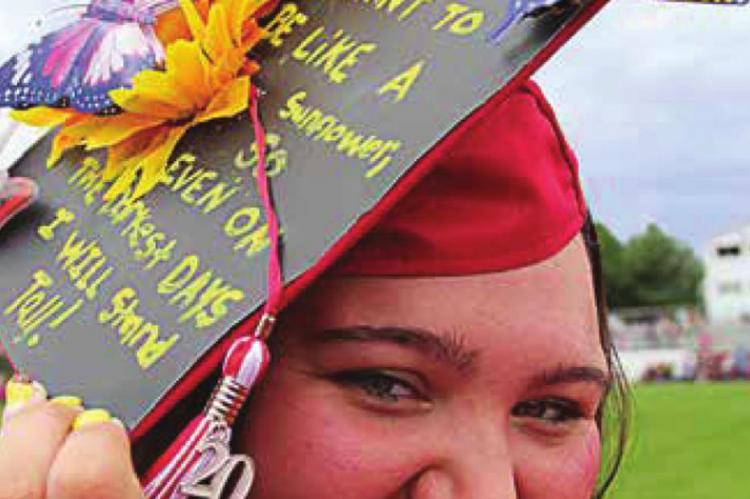 BRIANNA HOLTZCLAW shows off her decorated mortarboard during graduation in June 2020.