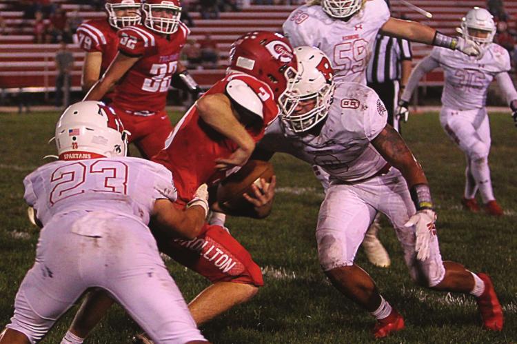 A WELCOME PART of Richmond’s game this year is defense. On this play, Carrollton sophomore quarterback Parker Minnick breaks to his right, arm back and ready to pass. But with Richmond senior linebacker Tanner Bennett in hot pusuit, Minnick cannot pass, so he cranks up the speed and runs toward the sideline where defenders, including Aiden Iveson and Keyshaun Elliott, slow him up to help bring him down. J.C. VENTIMIGLIA | Staff