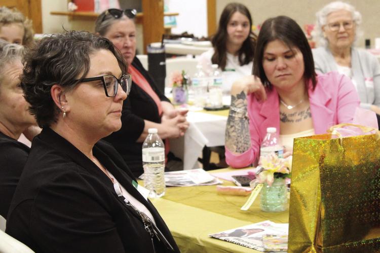 OUTSTANDING WOMAN in Business and Leadership nominee Cindy Thornberry (left) listens to the speaker along with other attendees of the luncheon and awards ceremony. MIRANDA JAMISON | Staff