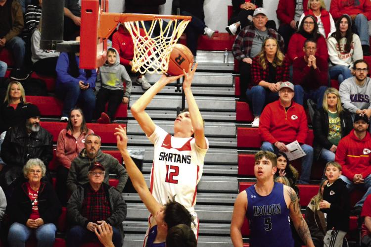 RICHMOND SOPHOMORE Gabe Johnson looks to bank in a short jumper Feb. 3 during the first half of the Spartans’ 78-19 courtwarming thumping of Holden in Missouri River Valley Conference East Division action. SHAWN RONEY | Staff