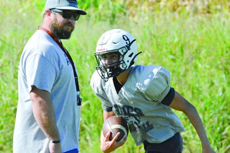 NORBORNE HARDIN-CENTRAL varsity 8-man football coach Andrew Watson (left), shown watching Brody Fifer during practice Tuesday at Hardin-Central, can add his first victory over Sweet Springs to his list of achievements. SHAWN RONEY | Staff