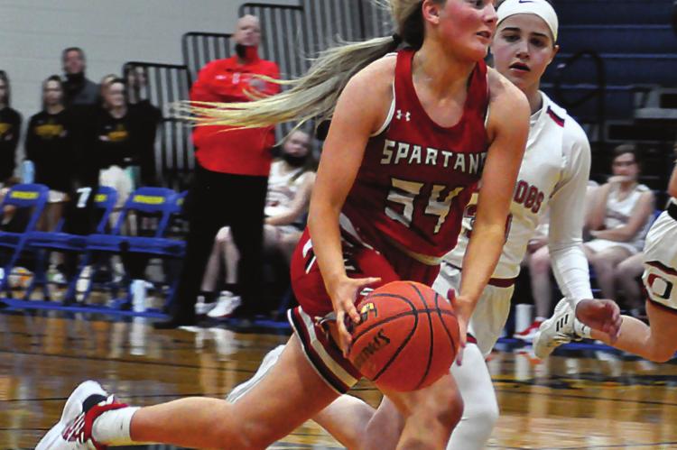 RICHMOND SENIOR Emmalea Kilpatrick pushes the ball down the court during the fourth quarter of the Spartans’ three-point loss Tuesday to Odessa at the Husker Classic in Higginsville. SHAWN RONEY | Staff