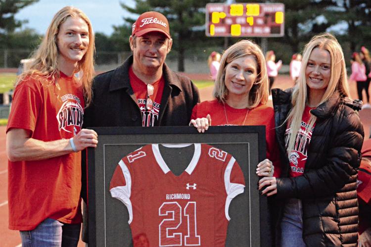 EVAN VANDIVER’S football jersey has been retired at Richmond High School. Family members displaying the jersey before Richmond’s Oct. 13 meeting with visiting Knob Noster are (from left) Ashton, Gary, Penny and Abby Vandiver. SHAWN RONEY | Staff