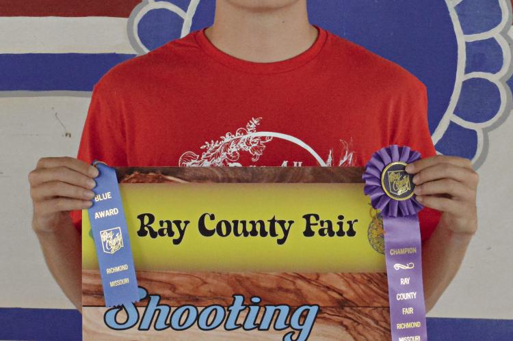 SILAS O’DELL of the Millville 4-H Club displays his Archery Best of Show banner and ribbons July 13 at the Ray County Fairgrounds in Richmond. SHAWN RONEY | Staff