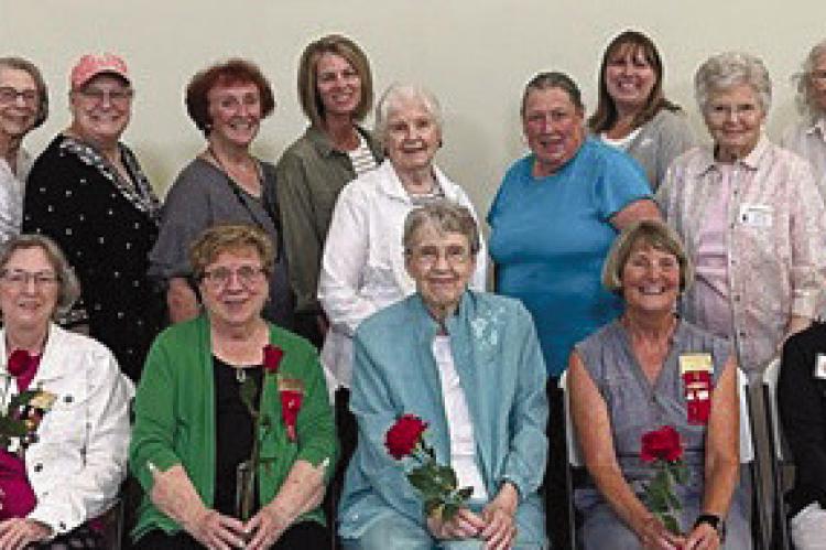 At a special meeting this summer, Beta Tau presented roses and honored long-time members Linda Cain (seated from left), Nancy Smith, Judy Salter, Claudetta McCorkendale, Opal Richardson, Mary Pettegrew and Joan Judd. Additionally, Joyce Barrett (standing from left), Dona Philips-Proffitt, Judy Waters, Lynette Morris, Roberta Stoenner, Lisa Thacker, Billie Hamann, Jayne Taylor, Kerri Prom, June Harrison, Maggie Presson, Amber Opfer, Joyce Sayegh and Brenda Hamm. Submitted