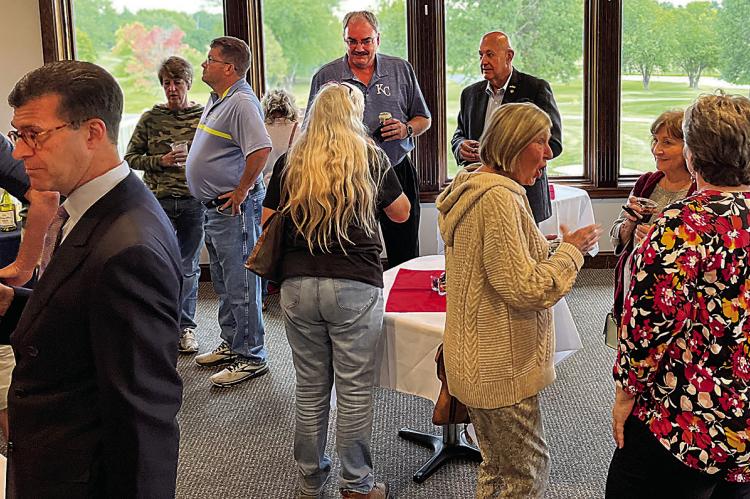 FOR THE SECOND MONTH in a row, state Rep. Terry Thompson, back right, attended a Richmond Area Chamber of Commerce after-hours event. Nancy Gilbert, second from right, won the Kansas City Chiefs tickets in the night’s drawing. SOPHIA BALES | Staff