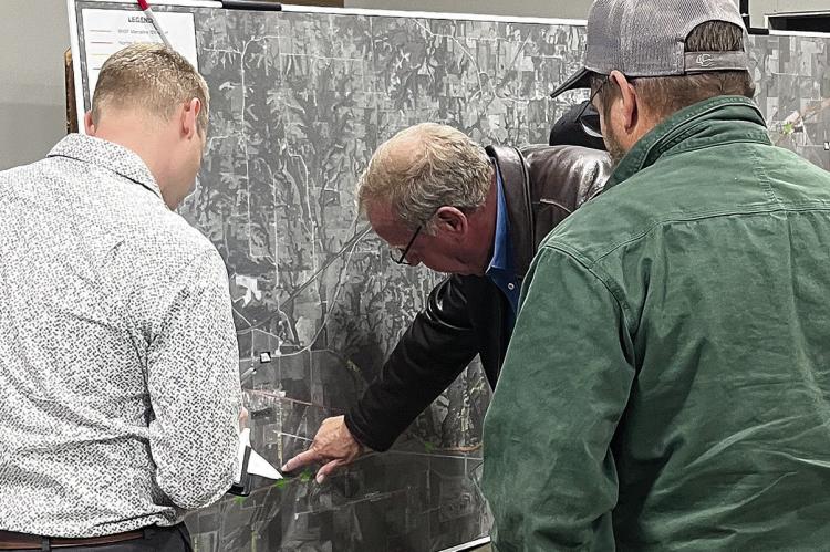 CMT SR. RAIL Planning Lead Eric Curtit view the display map with others. SOPHIA BALES | Staff