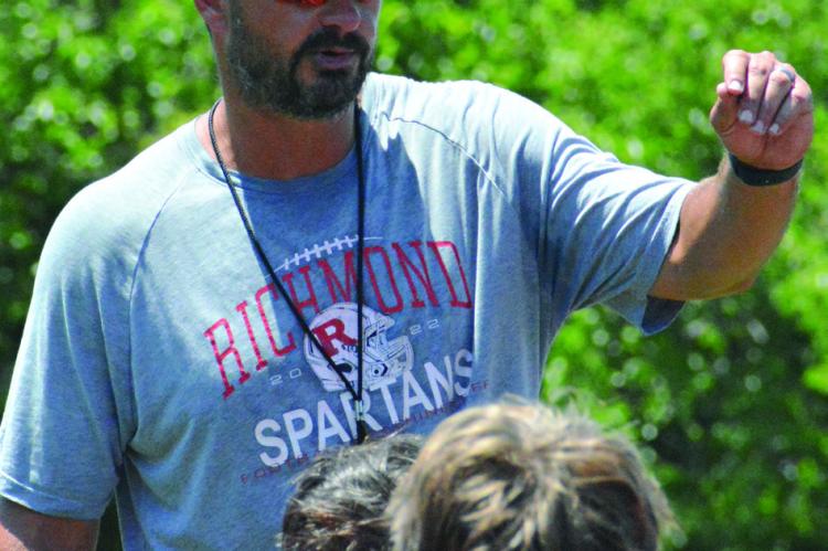 RICHMOND FOOTBALL COACH Nick Persell talks to his players to cap a team camp session. SHAWN RONEY | Staff