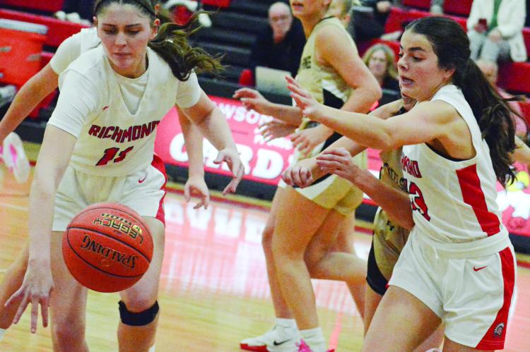 CANDIACE CLAYPOLE (left) and Genevieve Didier pursue a loose ball for Richmond in the Lawson Invitational. SHAWN RONEY | Staff