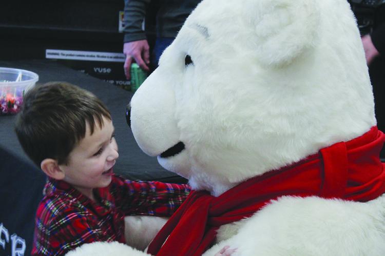 TOMMY GOOD goes in for a hug with the polar Bear.