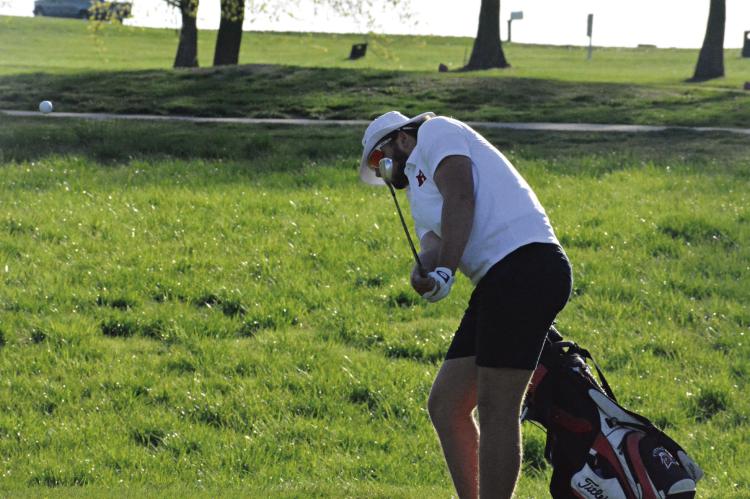 SENIOR JACK GOGUE hits a chip shot during Richmond’s varsity boys golf dual with Odessa Monday at Shirkey Golf Course. SHAWN RONEY | Staff