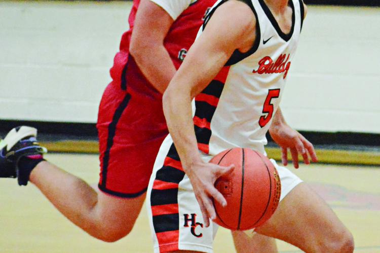 HARDIN-CENTRAL SENIOR Kameron Pugh drives the lane with the basketball against Northland Christian during the Bulldogs’ Nov. 17 season and home opener. SHAWN RONEY | Staff