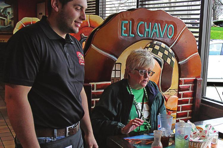 AT TEQUILA JALISCO, restaurant doors remain open and Heraldo Hacentio waits on Janis Kincaid during the pandemic. A few days later, all Ray County restaurants close to walk-in customers. J.C. VENTIMIGLIA | Staff