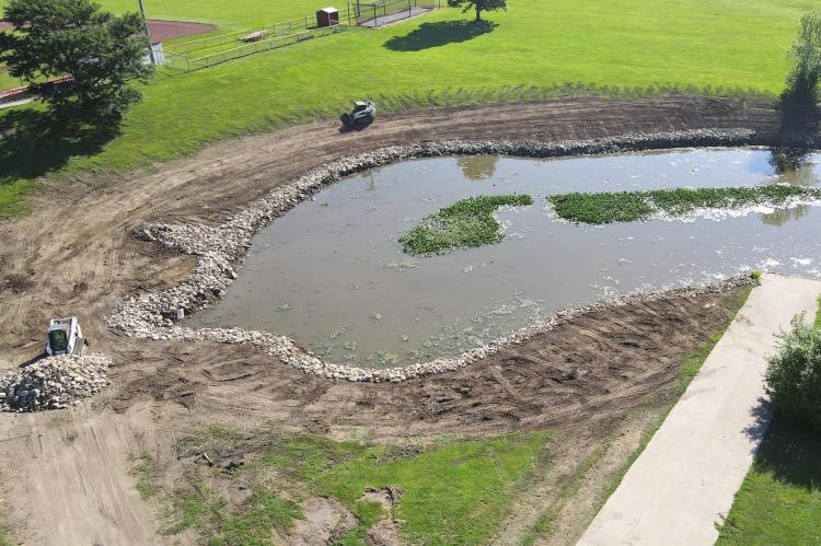 MACEY EXCAVATING can be seen grading Southview Lake’s bank and cleaning the area around the lake of underbrush and debris. Rip-rap rock is being placed around the shore to prevent erosion. BRIAN RICE | Publisher