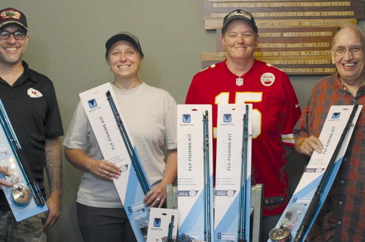 JESSE GRECO (from left) and Courtney Bock from South O Bones LLC donate fly-fishing equipment to Daitlin Cowley and Robert Cox of Special Needs services. SHARON DONAT | Staff