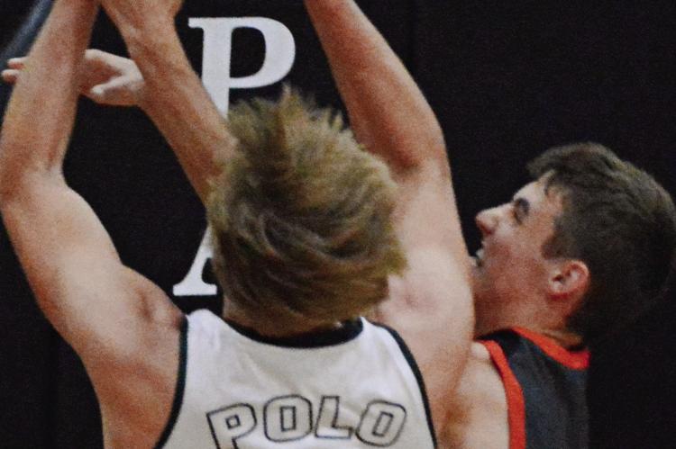 POLO SENIOR Maverick Gentry (left) and Hardin-Central sophomore Brody Fifer fight for a first-half rebound.