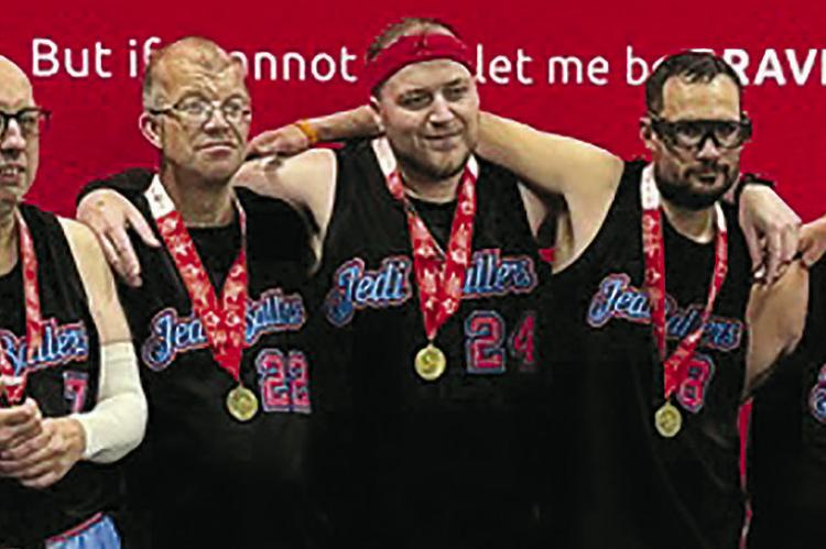 COACH RYAN HERRERA (from left) celebrates with David Lamar, Brian Harrison, Caleb Shockey, Cody Stevens, Hannah Kinard and John Connor after earning a gold medal with 20-4 and 20-6 wins at the Special Olympics basketball tournament in Jefferson City. Submitted