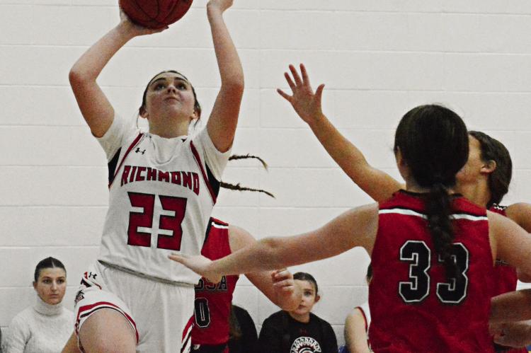 RICHMOND SOPHOMORE Emma Hash draws a pack of Bulldogs as she attempts a second-half layup against Odessa Monday night in the Husker Classic in the west gym of the Lafayette County C-1 campus in Higginsville. SHAWN RONEY | Staff
