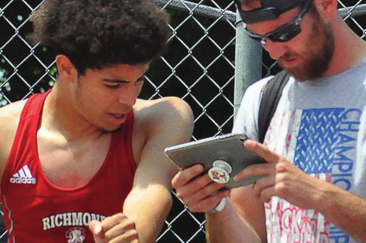 RICHMOND student-athlete Dionte Marquez, reviewing his technique with jumpers coach Jacob Swope at the 2019 Class 3 state track and field meet SHAWN RONEY | Staff in Columbia, looks to continue his athletic career at the University of Central Missouri in Warrensburg. Swope plans to follow Marquez’s career at UCM.