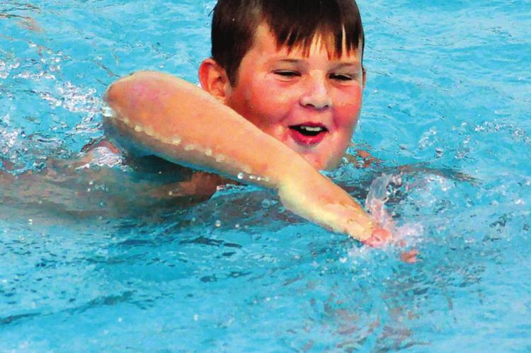 DOLPHIN Swim Team member Jett Shane swims a few freestyle strokes after diving into deep water during his swim-a-thon Sunday at Southview Pool to raise money for the Arthritis Foundation. SHAWN RONEY | Staff