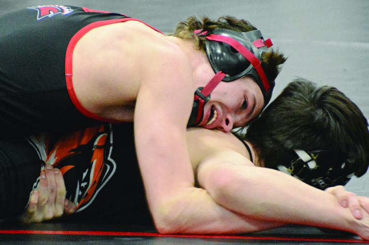 SENIOR BRADY HYDER works on the right arm of Kirksville’s Jason Schutter while wrestling in the top position during the title match for the 126-pound division at the Richmond Invitational. It was Hyder’s final home match. SHAWN RONEY | Staff