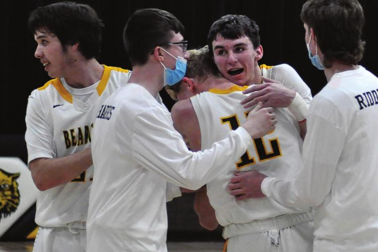 LED BY senior Ethan Wilson embracing junior Blake Buchanan, the Bearcats celebrate their sectional victory Tuesday night at Orrick. SHAWN RONEY | Staff