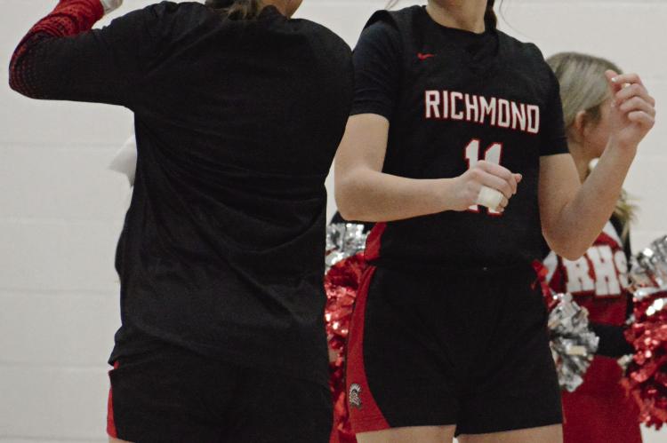 CANDIACE CLAYPOLE (right) shows she’s ready to play as she is introduced before Richmond’s Husker Classic opener with Excelsior Springs. SHAWN RONEY | Staff