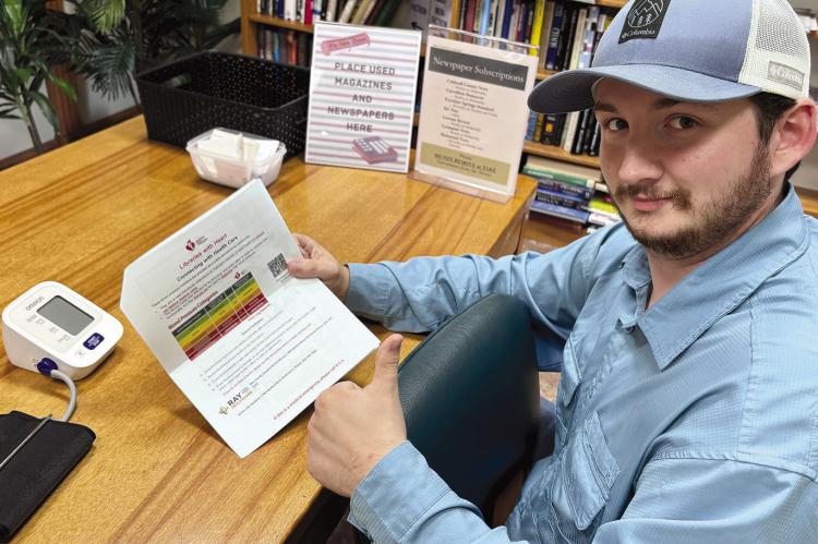 AN AREA RESIDENT reads up on ways to monitor blood pressure. JOSHUA BRUNGARDT | Staff