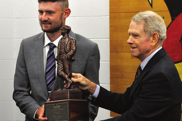 DYLAN COMSTOCK receives the Kenneth Smith Award from Patrick McMahon. SHAWN RONEY | Staff