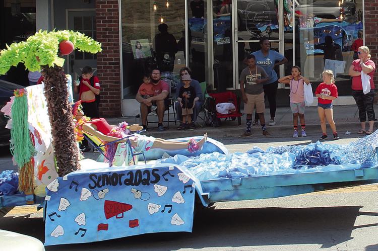THE SENIOR CLASS beach-themed floats rolls through the streets during the homecoming parade. SHARON DONAT | Staff