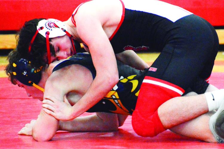 SENIOR JOE BURCH III, top, works to break down Penney of Hamilton’s Hunter Nixdorf Jan. 5 at Richmond High School. SHAWN RONEY | Staff