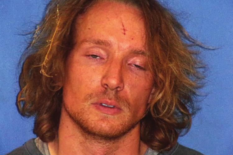 WITH GRASS still in his hair following his arrest near Elkhorn Elementary School, in a farmer’s field where he appeared to be trying to hide from law enforcers, Richard Anthony Arrington, 30 Kansas City, is photographed during booking.