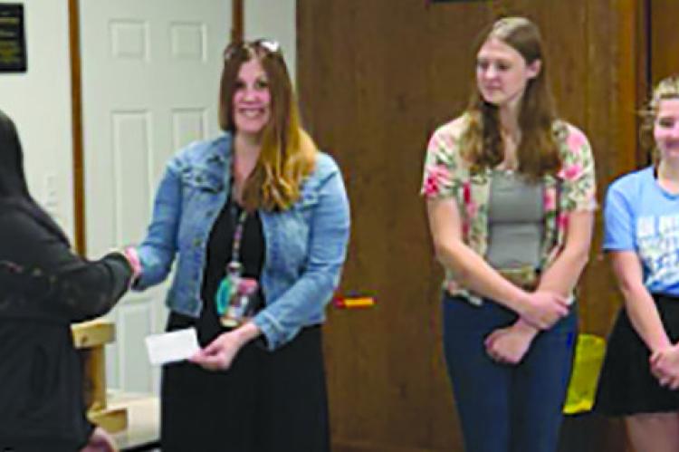 GUYS &amp; GALS 4H Treasurer Trinity Thomas (from left) presents a check to Dear Elementary affiliate Sarah Kennedy with President Taylor Reeves and Vice President Amanda Wollard. Submitted
