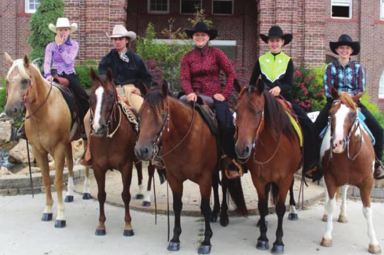 GUYS AND GALS 4-H members with their horses stand outside the State Fairgrounds last week during competition.