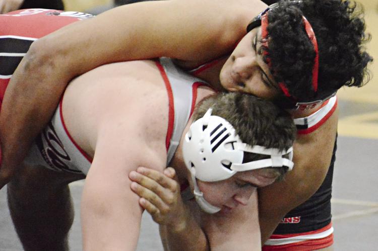 RICHMOND SENIOR Hayden Happy (top) works to break down Odessa’s Zeke Bergen in the 190-pound Class 2 District 4 wrestleback semifinals Feb. 17 at Excelsior Springs. SHAWN RONEY | Staff