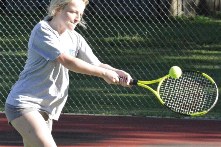 CARSYN TEAT works on her two-fisted backhand during a training session for Richmond High School girls. SHAWN RONEY | Staff