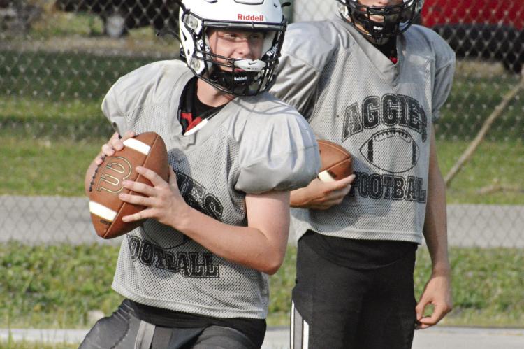 COUSINS AND NORBORNE HARDIN-CENTRAL teammates Zach Deitch (left) and Brody Fifer work on their passing accuracy and engage in some friendly family competition at team camp June 30 at Hardin-Central. SHAWN RONEY | Staff