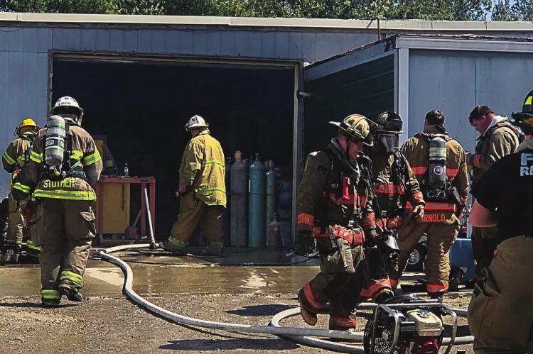 FIREFIGHTERS from Richmond and area communities contain a business fire on East Main Street. RICHMOND FIRE DEPARTMENT