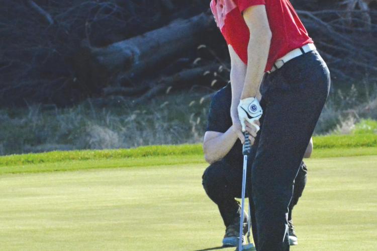 SENIOR AIDEN BOWMAN attempts a putt during Richmond’s boys golf dual with Lawson on Monday at Shirkey Golf Course. SHAWN RONEY | Staff
