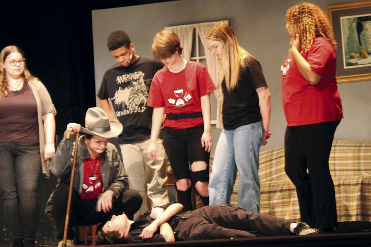 TIMOTHY VAUGHN, lying on the floor, is surrounded by Hannah Hayes (from left), Jazspher Ulleberg, Zavier Davis, Raigan Braley, Alaina England and Kara Clavton, performing a murder scene during the Richmond High School drama team’s production of the play. This weekend’s performances are Friday and Saturday at 7:00 p.m. Sunday at 2:00 p.m. at the Farris Theater. SHARON DONAT | Staff