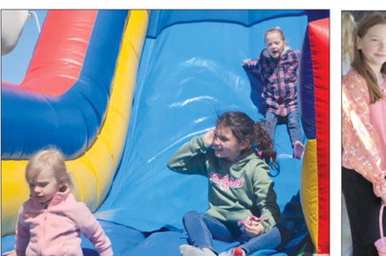 CHILDREN MAKE their way down an inflatable slide as Easter festivities MIRANDA JAMISON | Staff