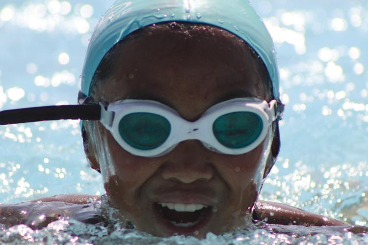 ERIANNA ELEGINO pushes through a breaststroke heat during a summer swim meet. SHARON DONAT | Staff