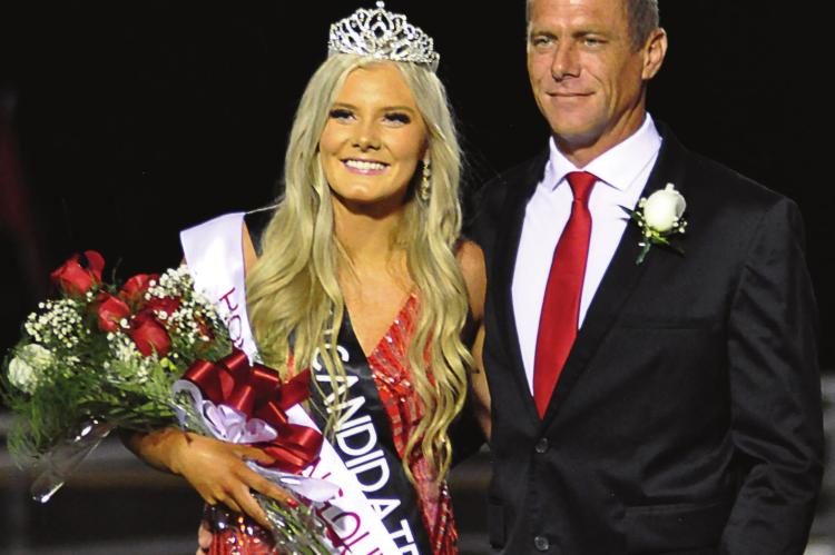 SENIOR EMMALEA KILPATRICK, escorted by her dad, Jeremy, is crowned homecoming queen during halftime of Richmond’s 35-26 Sept. 24 homecoming loss. Collin Cromley is crowned king. SHAWN RONEY | Staff