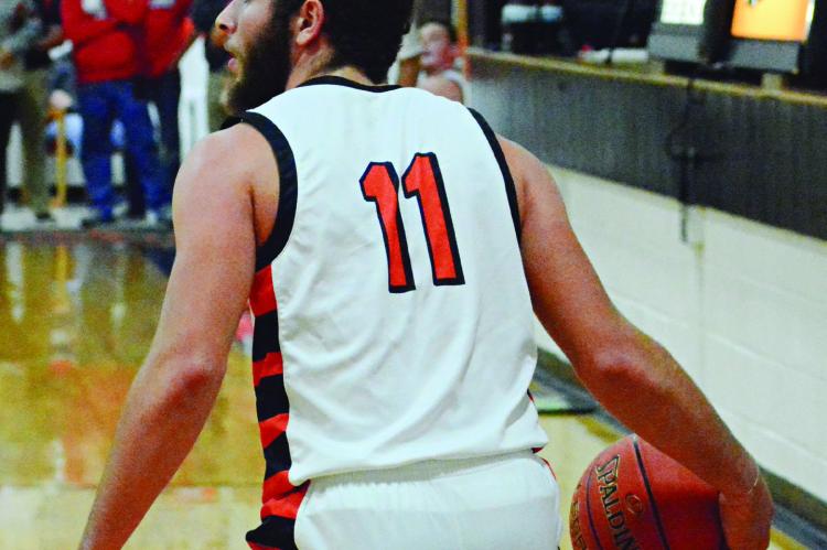 DENVER DOUGLAS shields the ball with his hip as he looks to make a firsthalf pass for Hardin-Central Dec. 7 against visiting Carrollton. SHAWN RONEY | Staff