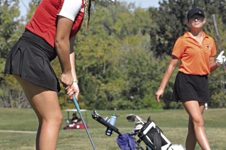 WITH A member of her group watching from behind, Richmond junior Kylie Holland attempts to putt Oct. 5 during Class 2 District 4 play at Lawson. SHAWN RONEY | Staff